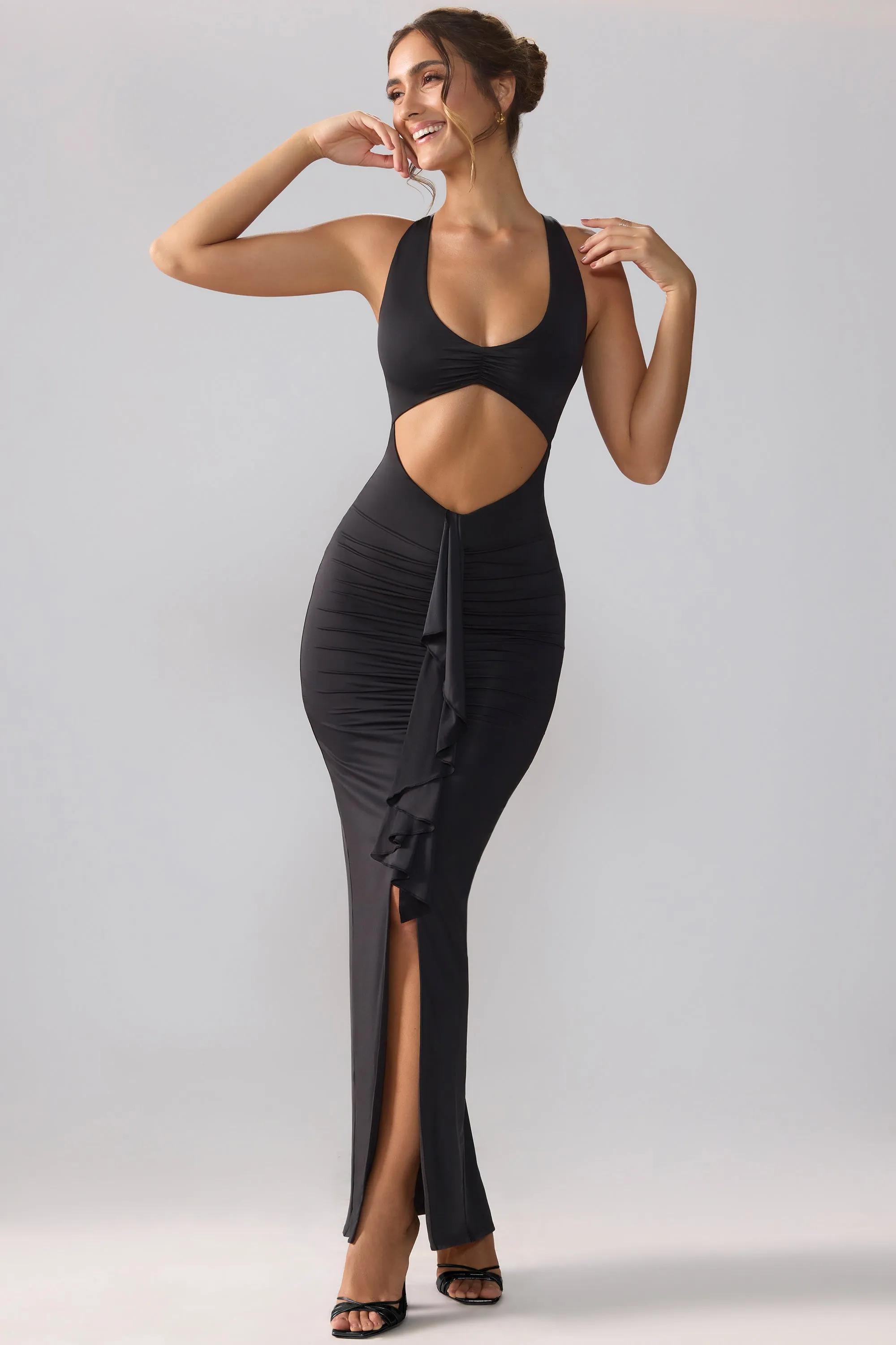 This dress offers a flattering shape that can easily be accessorized for a variety of looks Slinky Jersey Cut Out Ruffle Racerback Maxi Dress in Black