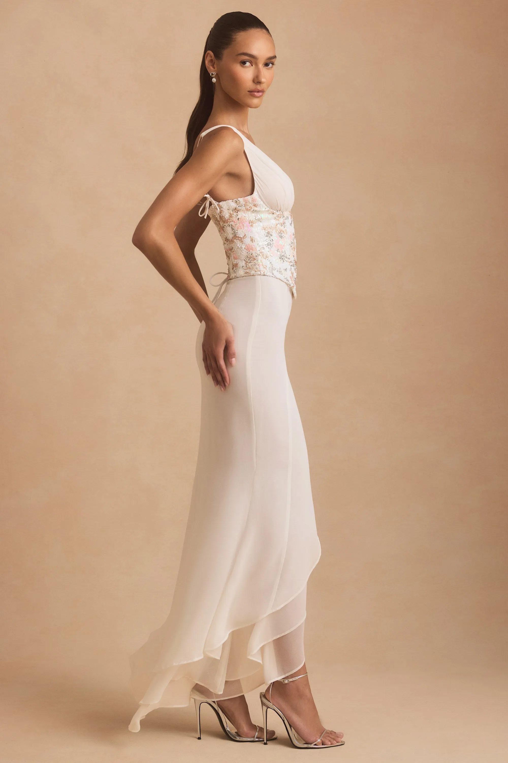 Embellished Plunge Ruffled Corset Maxi Dress in Ivory With its simple silhouette this maxi dress offers a flattering look for all body types
